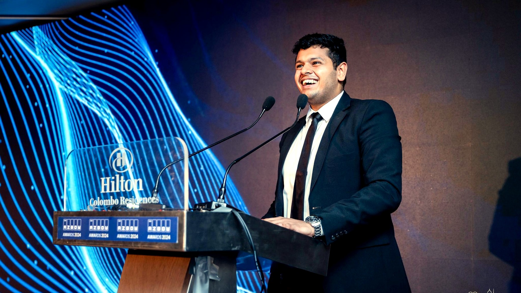Yohan speaking at an event